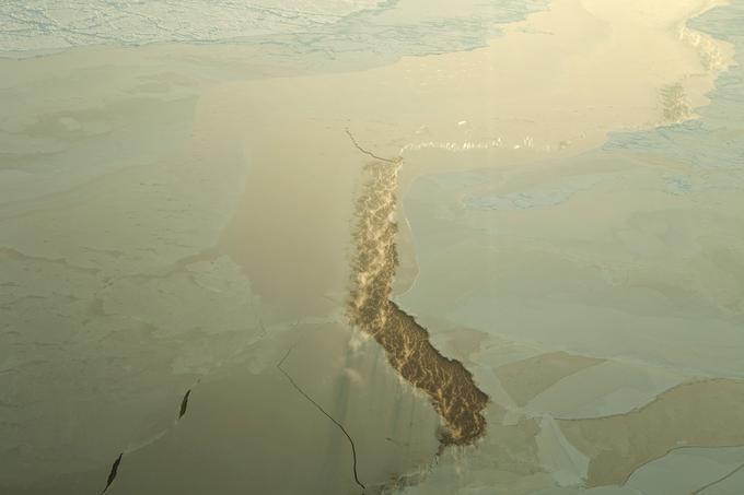 Skozi razpoko v ledu uhaja para. | Foto: Reuters